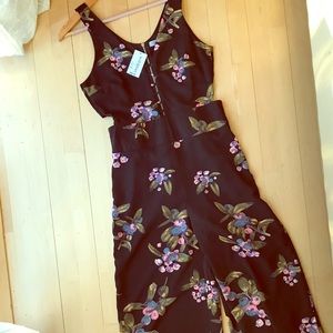 Black jumpsuit with cutouts on sides.